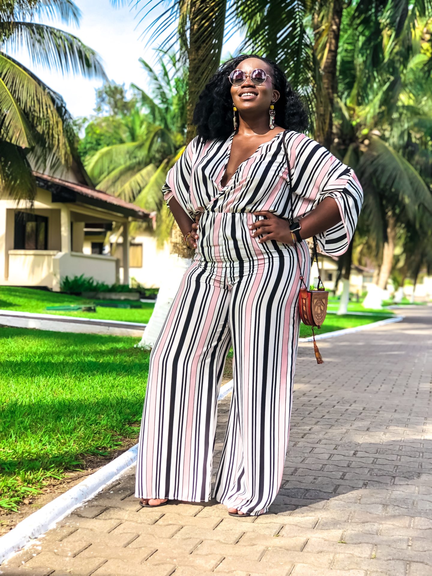 Boston based African blogger Binja, the Africancocktail, is wearing a stripped jumpsuit from Charlotte Russe. Africancocktail is in Busua, Ghana.