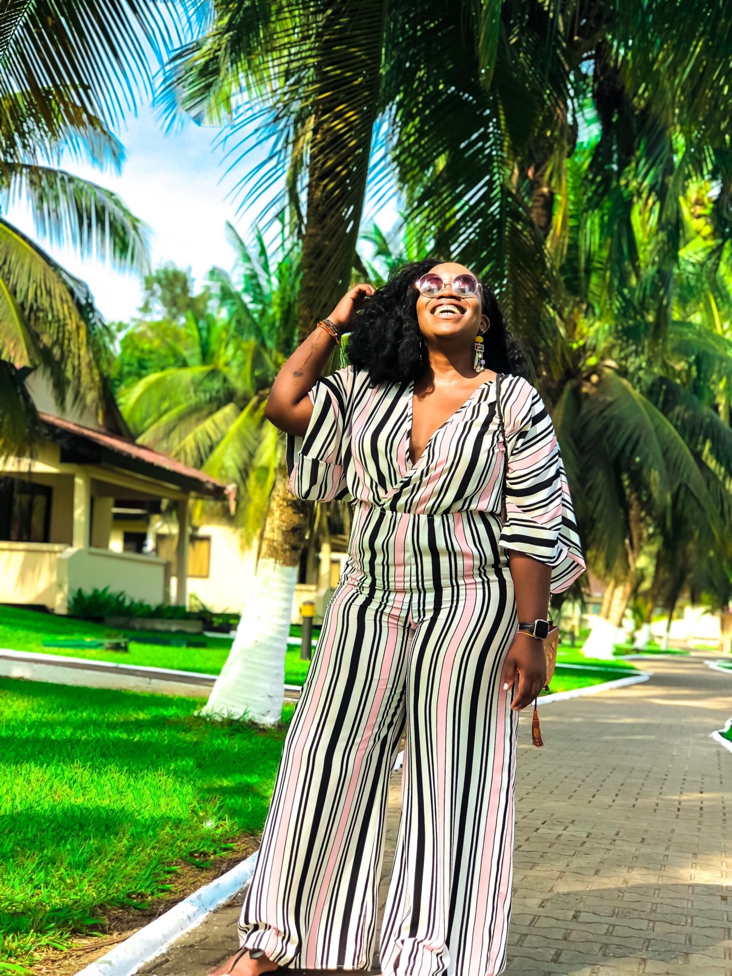 Boston based African blogger Binja, the Africancocktail, is wearing a stripped jumpsuit from Charlotte Russe. Africancocktail is in Busua, Ghana.